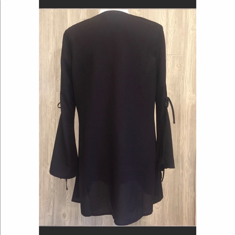 Black sheer top with details on the sleeves